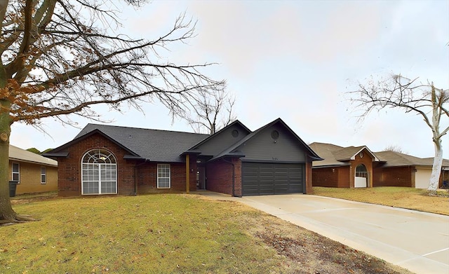 single story home featuring an attached garage, a front yard, concrete driveway, and brick siding