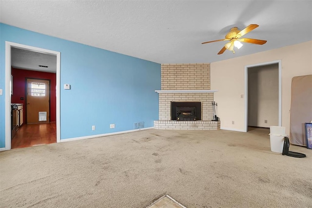 unfurnished living room with a textured ceiling, carpet flooring, and visible vents