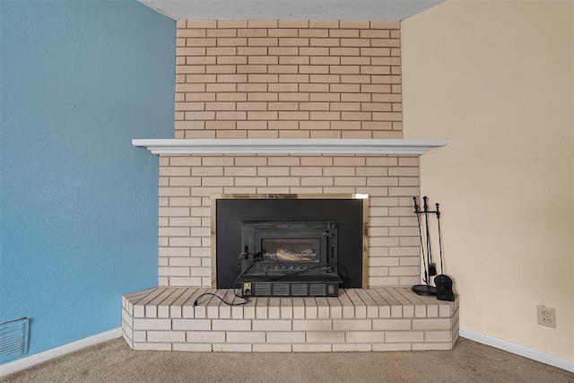 interior details with carpet floors, a fireplace, visible vents, and baseboards