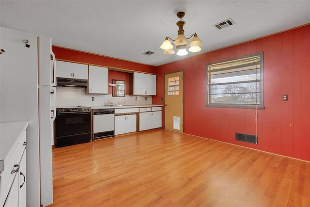 kitchen featuring white appliances, white cabinetry, visible vents, and under cabinet range hood