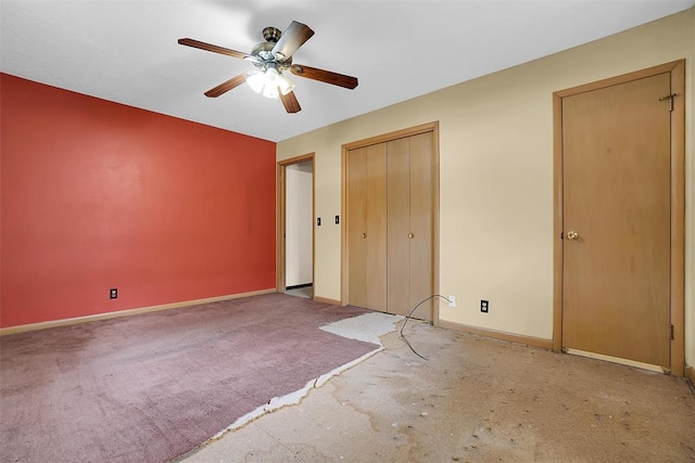 unfurnished bedroom featuring carpet floors, ceiling fan, baseboards, and a closet