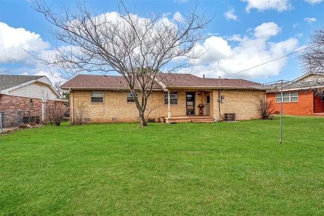 rear view of property with crawl space, brick siding, a yard, and central air condition unit