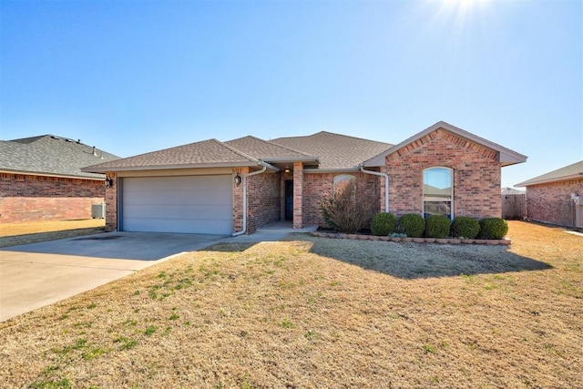 ranch-style home with central AC, concrete driveway, a front lawn, a garage, and brick siding