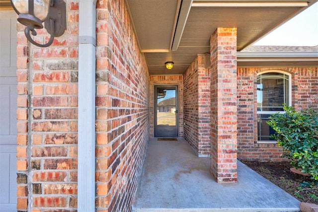 property entrance featuring brick siding