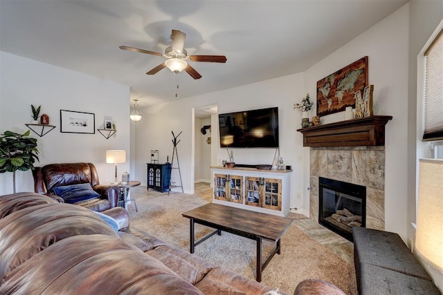 living room with a fireplace, a ceiling fan, and carpet