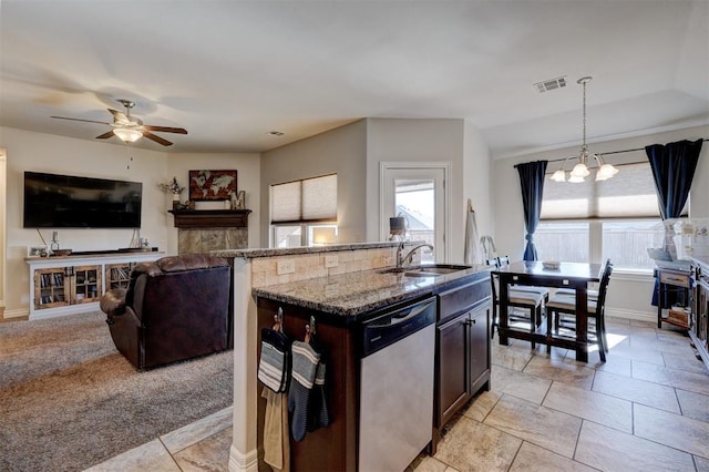 kitchen with visible vents, a sink, light stone counters, light colored carpet, and dishwasher