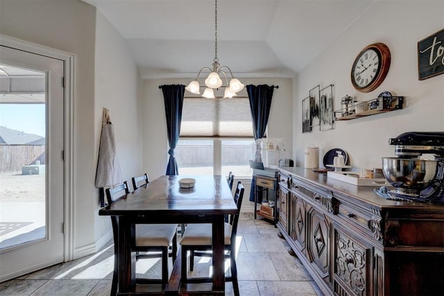 dining space featuring lofted ceiling, a notable chandelier, baseboards, and stone finish flooring