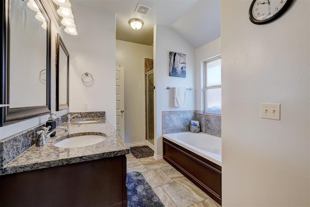 bathroom featuring visible vents, a stall shower, a garden tub, and a sink