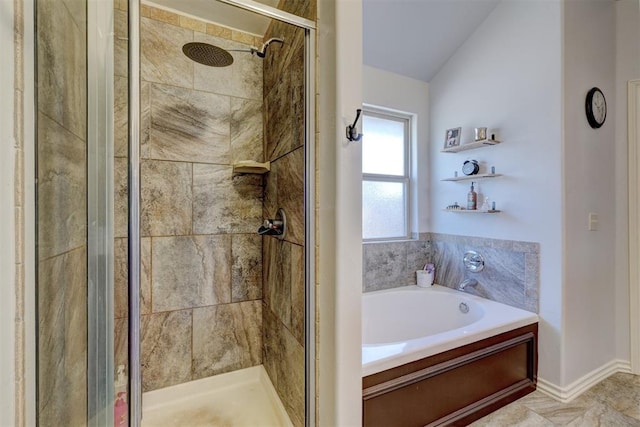 bathroom with lofted ceiling, a garden tub, and a shower stall