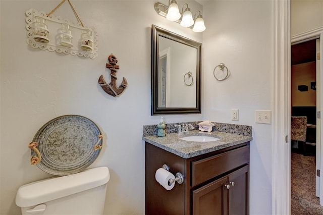 half bathroom with toilet and vanity