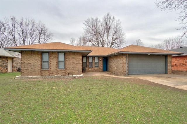 ranch-style house featuring a garage, a front yard, concrete driveway, and brick siding