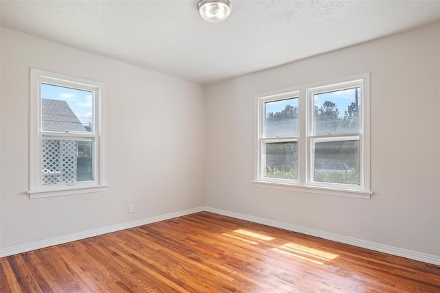 unfurnished room featuring baseboards and light wood-style flooring