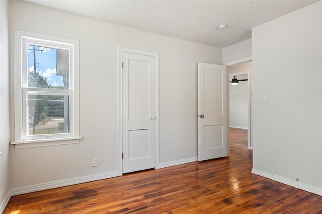 unfurnished bedroom featuring baseboards and wood finished floors