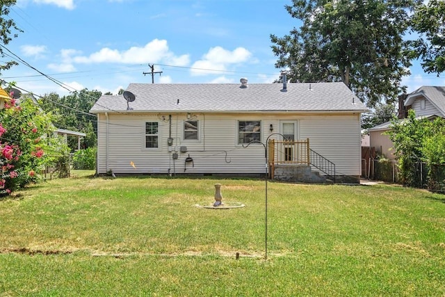 back of property featuring crawl space, a yard, and fence