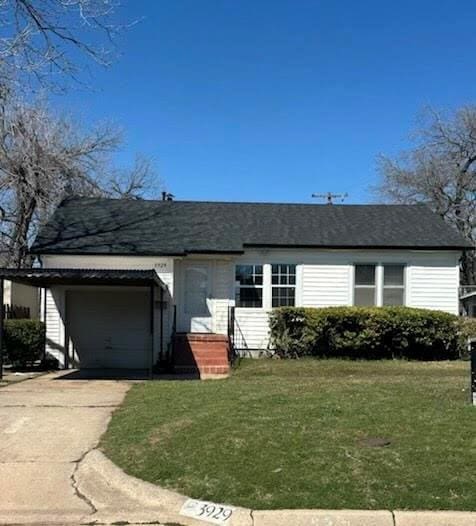 single story home with a garage, a front lawn, and driveway