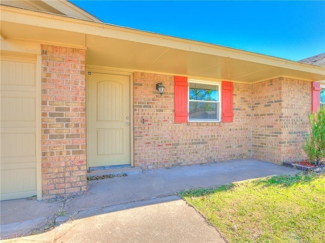 doorway to property with brick siding