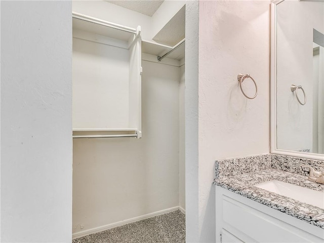 spacious closet with carpet and a sink