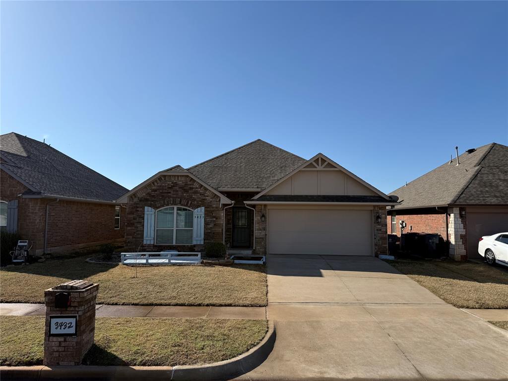 view of front facade featuring an attached garage, board and batten siding, a shingled roof, and concrete driveway