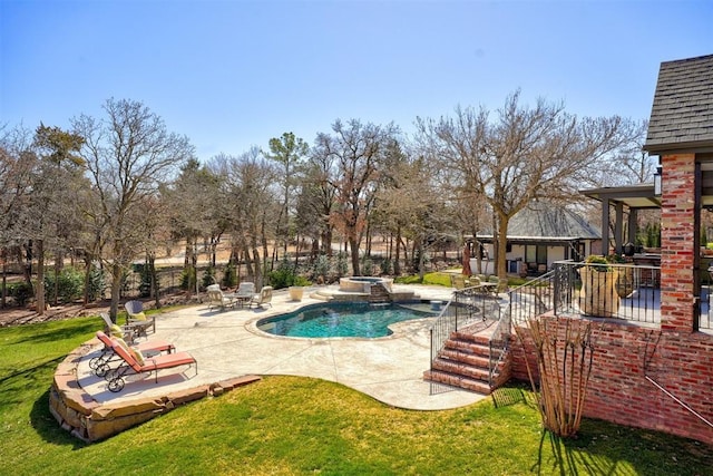 view of pool featuring a patio area, a lawn, and a pool with connected hot tub