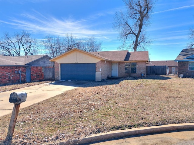 single story home featuring concrete driveway, a garage, fence, and brick siding