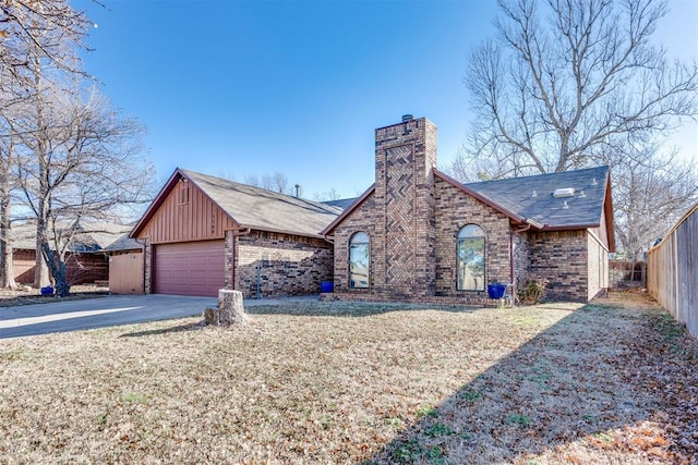 view of front of house featuring a chimney, fence, a front lawn, and brick siding