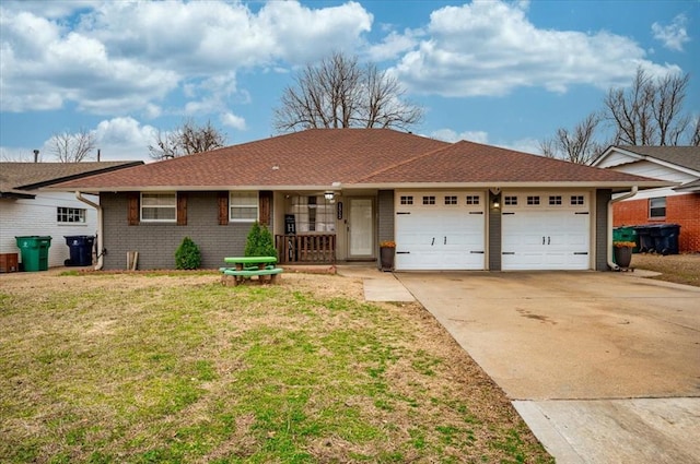 ranch-style house featuring a shingled roof, concrete driveway, an attached garage, a front yard, and brick siding