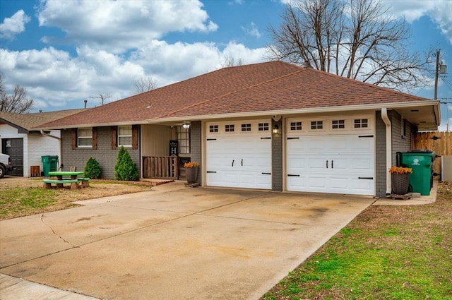 single story home featuring concrete driveway, brick siding, roof with shingles, and an attached garage