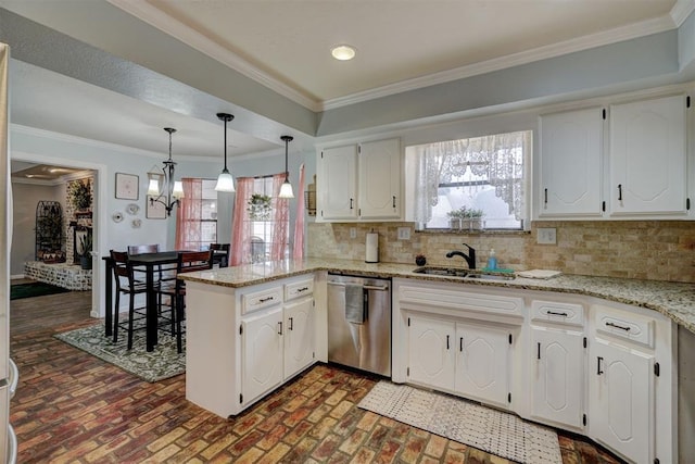 kitchen featuring a peninsula, ornamental molding, a sink, stainless steel dishwasher, and backsplash