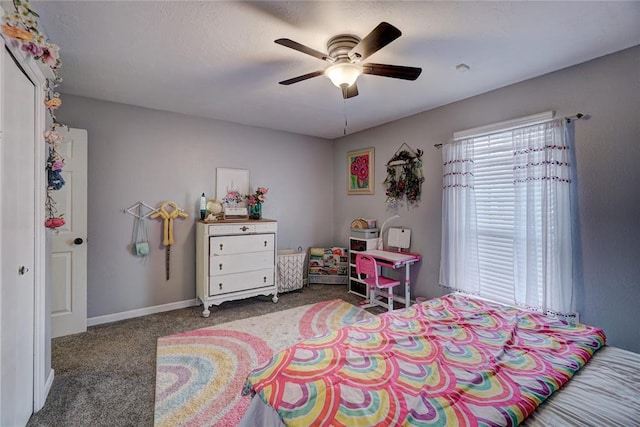 carpeted bedroom with a ceiling fan and baseboards