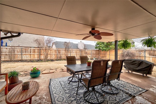 view of patio featuring outdoor dining space, a ceiling fan, and a fenced backyard