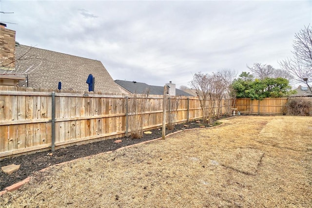 view of yard with a fenced backyard