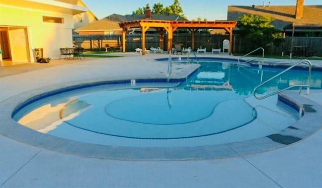 pool with a patio, fence, and a pergola