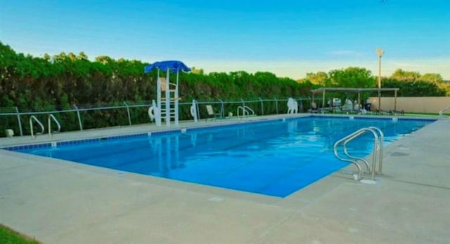 pool featuring a patio area and fence