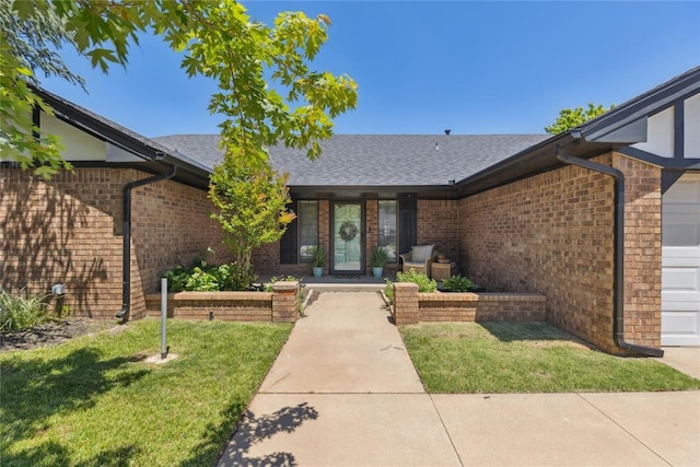 7217 NW 118th St, Oklahoma City, OK 73162 - entrance to property featuring brick siding, a lawn, and roof with shingles
