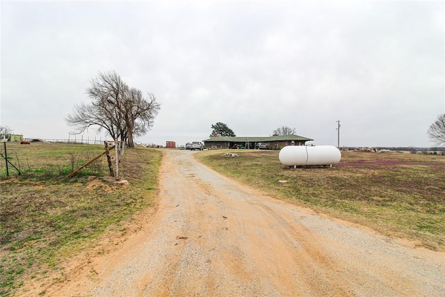 view of street featuring a rural view and dirt driveway