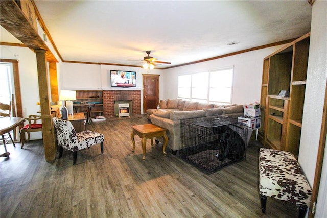 living room featuring ceiling fan, visible vents, crown molding, and wood finished floors