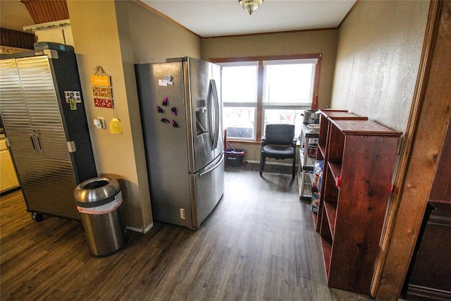 kitchen featuring dark wood-type flooring, stainless steel fridge with ice dispenser, and crown molding