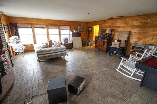 living room featuring wooden walls and a wall mounted AC