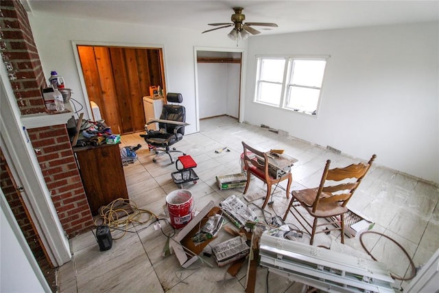 interior space with ceiling fan