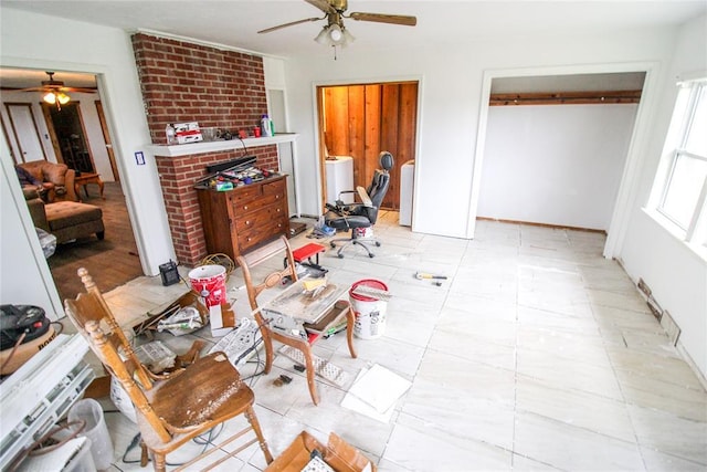 living area featuring washer / clothes dryer and ceiling fan