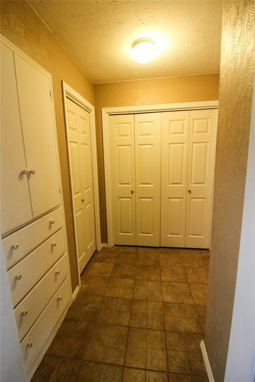 hall featuring a textured ceiling