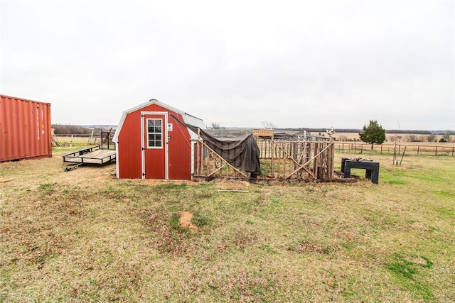 view of yard featuring a storage shed, an outdoor structure, and fence