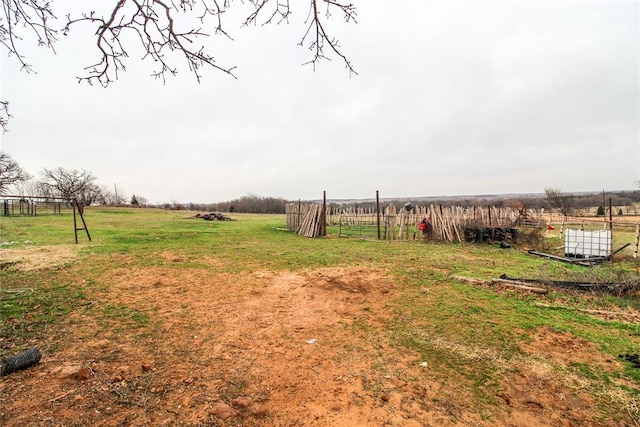 view of yard featuring a rural view and fence