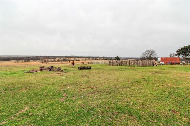 view of yard featuring a rural view and fence