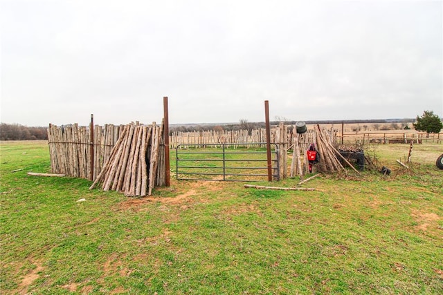 view of yard with a rural view and fence