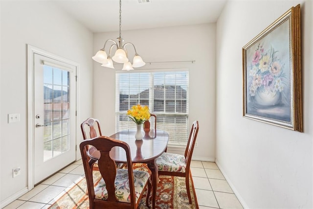 dining room with light tile patterned floors, baseboards, and a chandelier