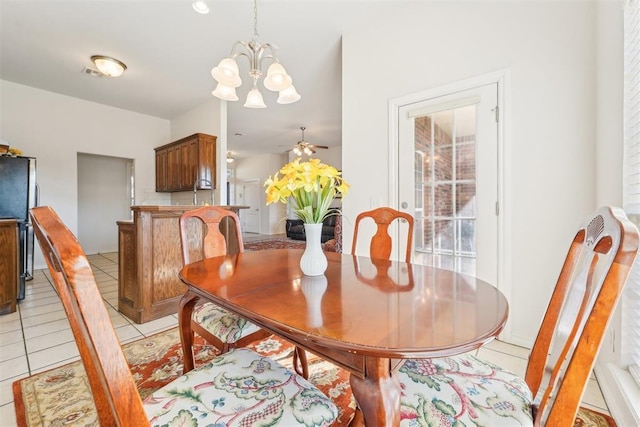 dining area with light tile patterned flooring, ceiling fan with notable chandelier, and visible vents