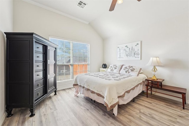 bedroom with light wood finished floors, visible vents, ceiling fan, baseboards, and lofted ceiling