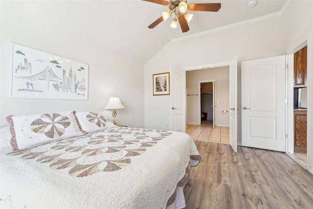 bedroom featuring vaulted ceiling, crown molding, wood finished floors, and ceiling fan