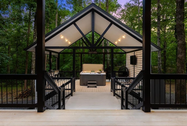 deck with a gazebo and a hot tub